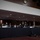 SECDEF, CJCS, CENTCOM Senate Armed Services Testimony A formal hearing or testimony session is taking place in what appears to be a U.S. Congressional hearing room. Three individuals are seated at a long draped table with name placards visible, including 'GEN Milley' and 'Sec. Austin', with a third placard partially visible on the right. Audience members wearing face masks are seated in the background, suggesting this occurred during the COVID-19 pandemic era.