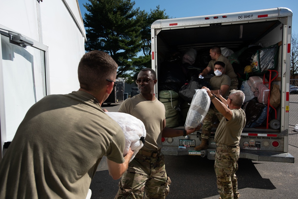 Oklahoma Air National Guardsman unloads donations in Liberty Village