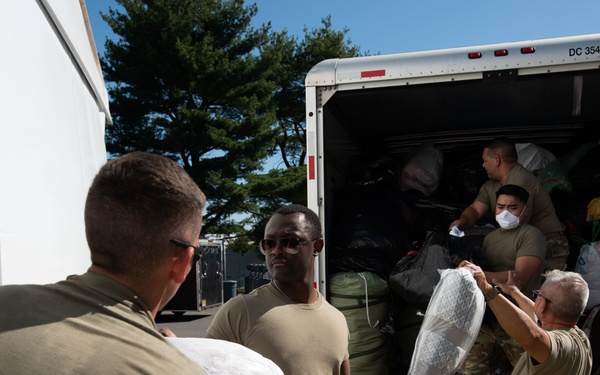 Oklahoma Air National Guardsman unloads donations in Liberty Village