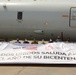 Multinational service members and distinguished visitors pose for a photo