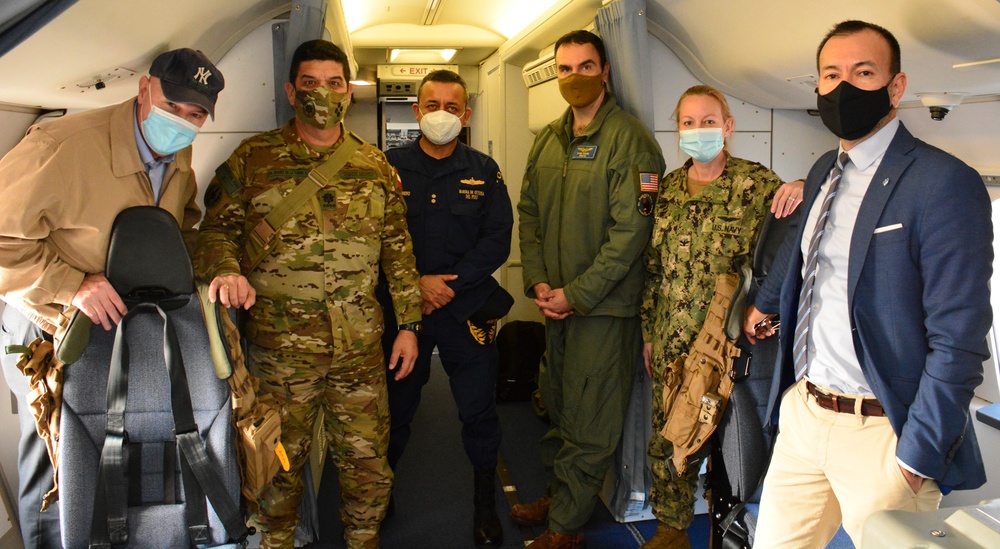Multinational service members and distinguished visitors pose for a photo