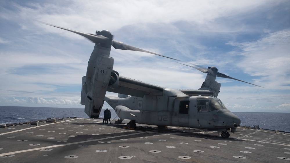 Sailors aboard USS Pearl Harbor guide MV-22B Ospreys from 11th MEU