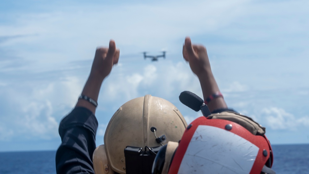 Sailors aboard USS Pearl Harbor guide MV-22B Ospreys from 11th MEU