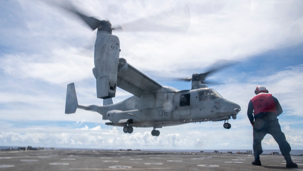 Sailors aboard USS Pearl Harbor guide MV-22B Ospreys from 11th MEU