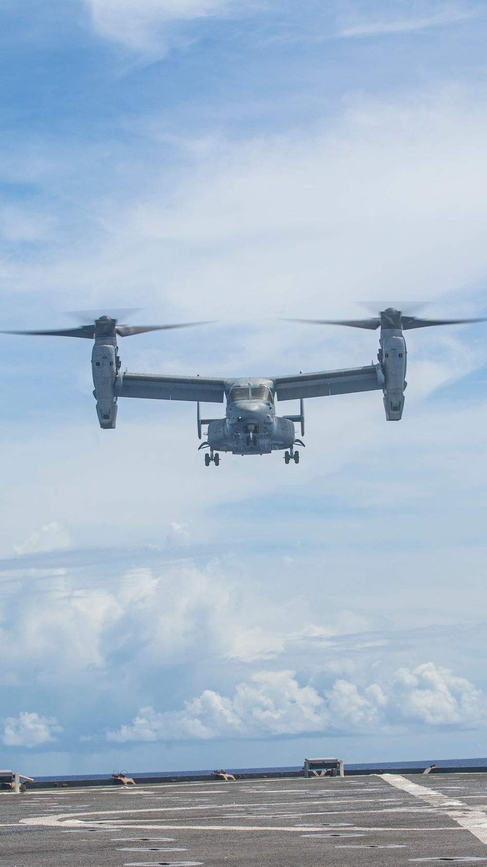 Sailors aboard USS Pearl Harbor guide MV-22B Ospreys from 11th MEU