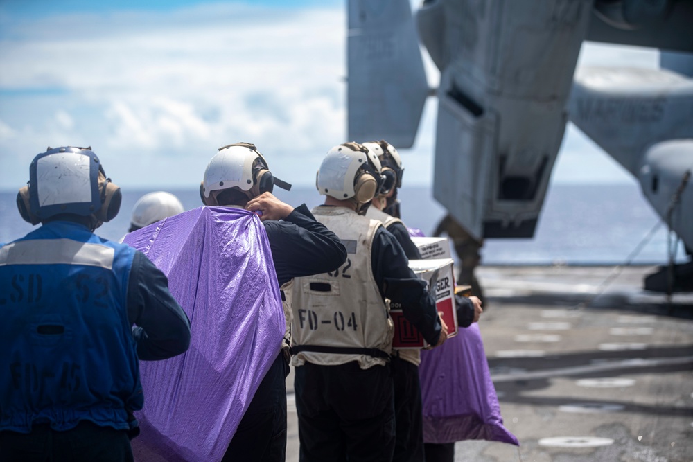 Sailors aboard USS Pearl Harbor guide MV-22B Ospreys from 11th MEU