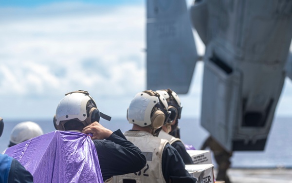 Sailors aboard USS Pearl Harbor guide MV-22B Ospreys from 11th MEU