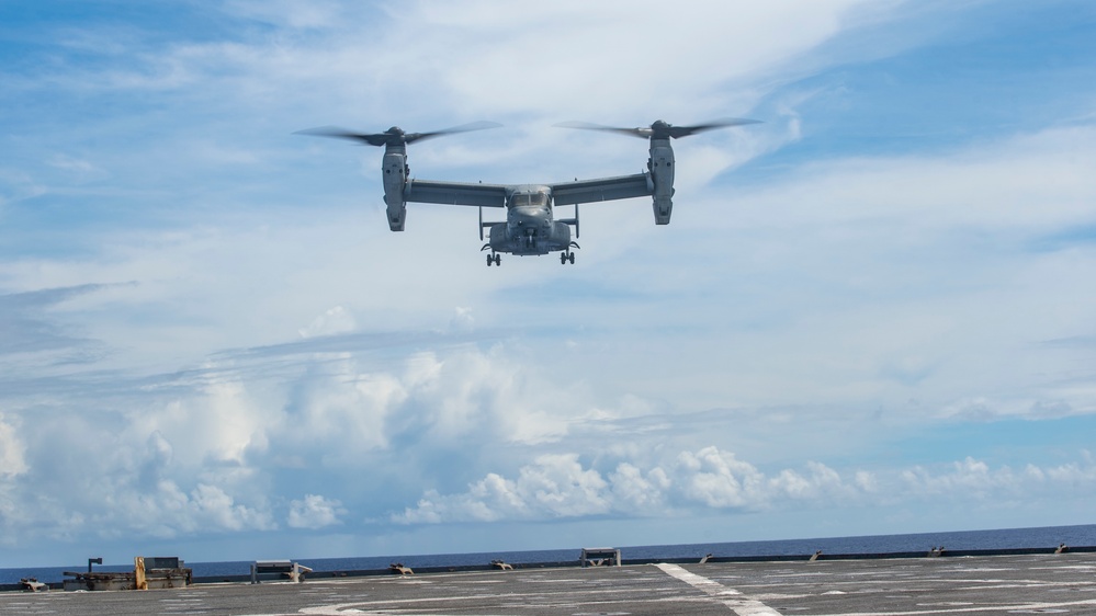 Sailors aboard USS Pearl Harbor guide MV-22B Ospreys from 11th MEU