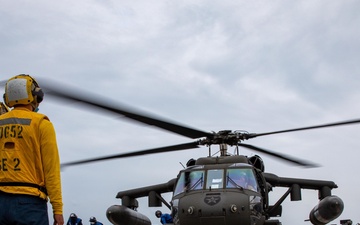 A U.S. Army UH-60 Black Hawk Conducts a Deck Landing Qualification on the Flight Deck with USS Barry