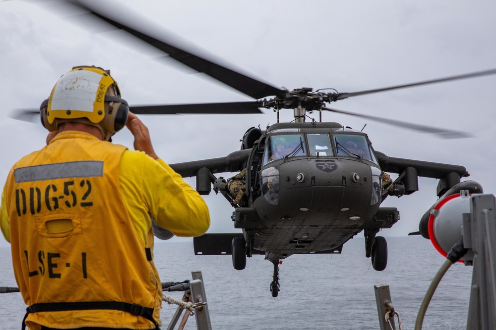 A U.S. Army UH-60 Black Hawk Conducts a Deck Landing Qualification on the Flight Deck with USS Barry