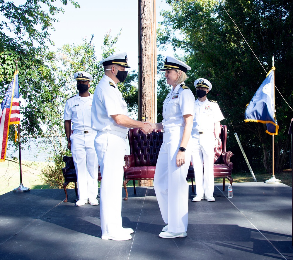 Captain Jason Schneider is congratulated by Commander Melissa Chope