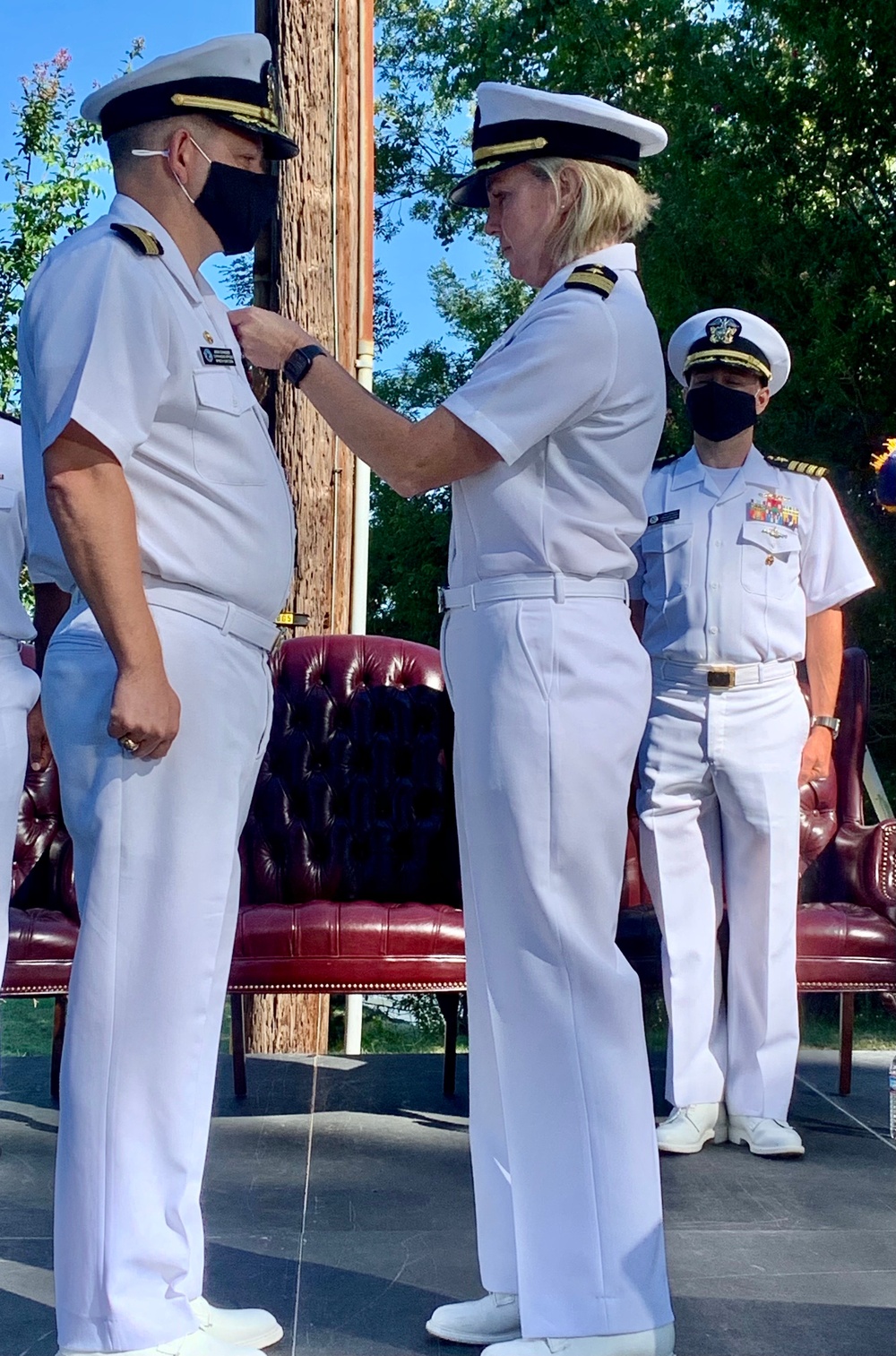 Captain Jason Schneider receives award from Commander Melissa Chope