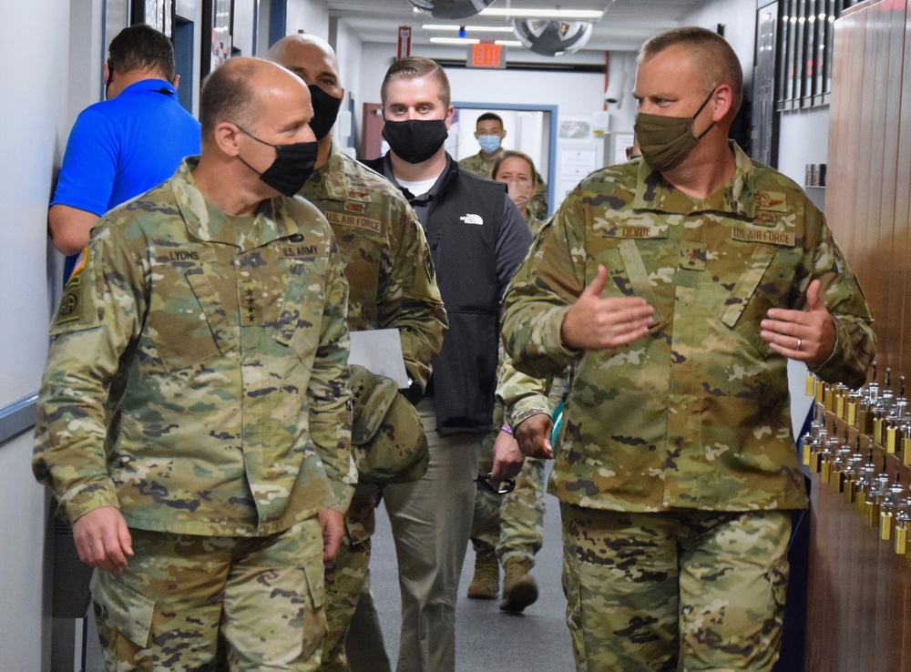 Gen Lyons is briefed by Brig. Gen. DeVoe during a visit to the 618th Air Operations Center.