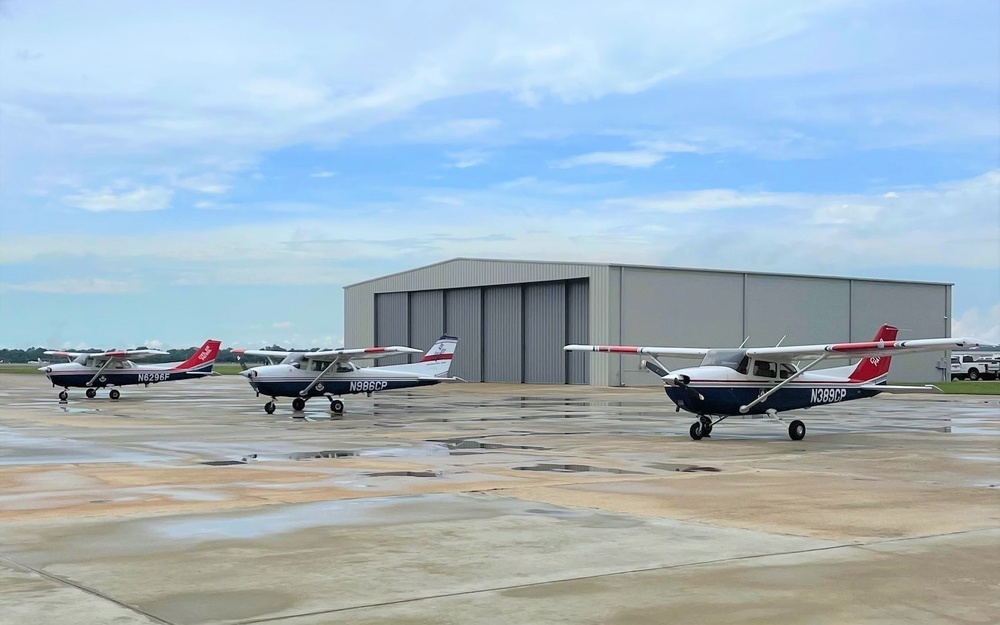 Thee Air Force Auxiliary airplanes stand ready to fly photography sorties as the weather clears