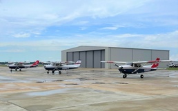 Thee Air Force Auxiliary airplanes stand ready to fly photography sorties as the weather clears