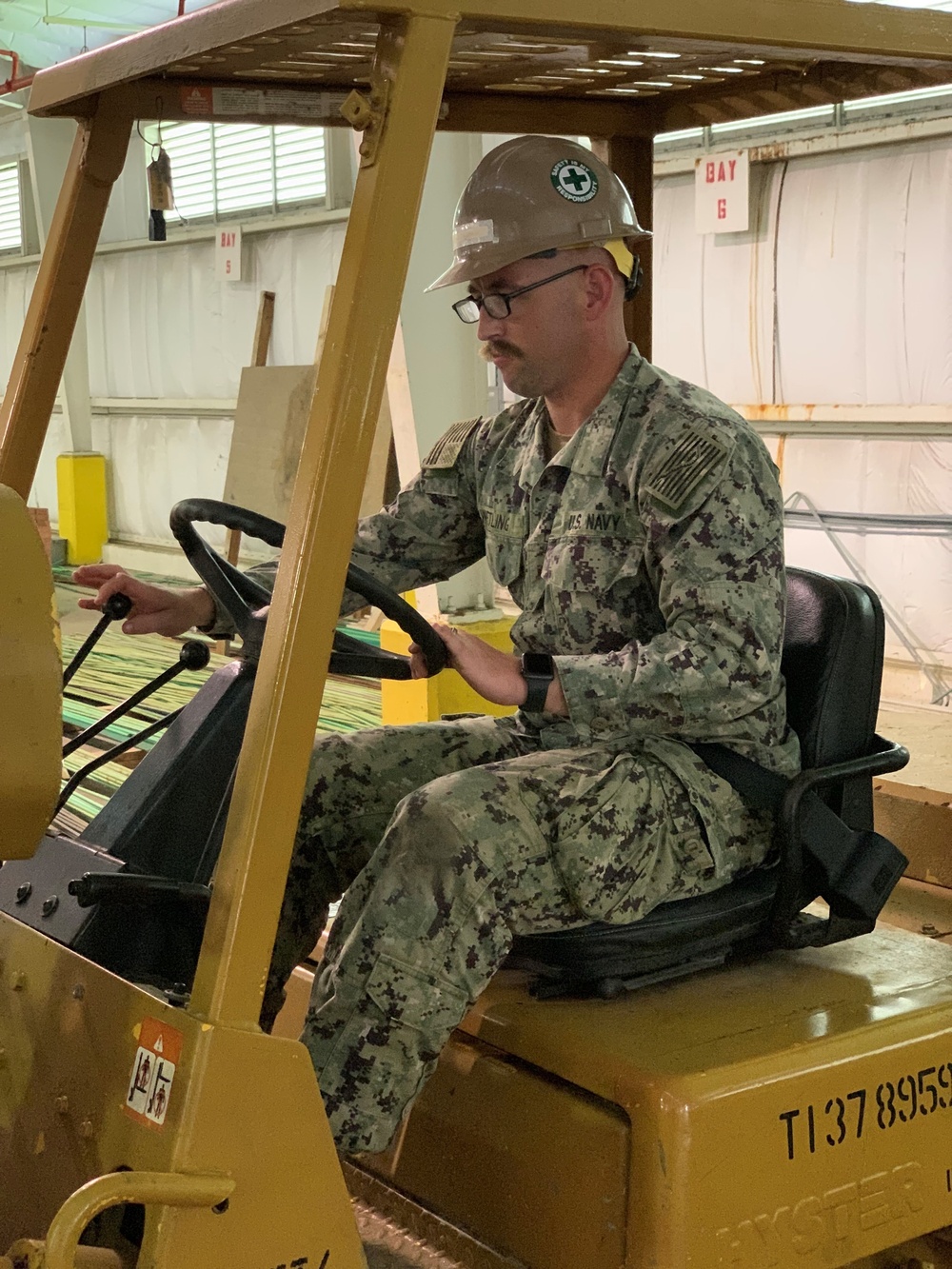 US Navy Seabees assigned to NMCB-5 prepare to build a gas cylinder storage unit