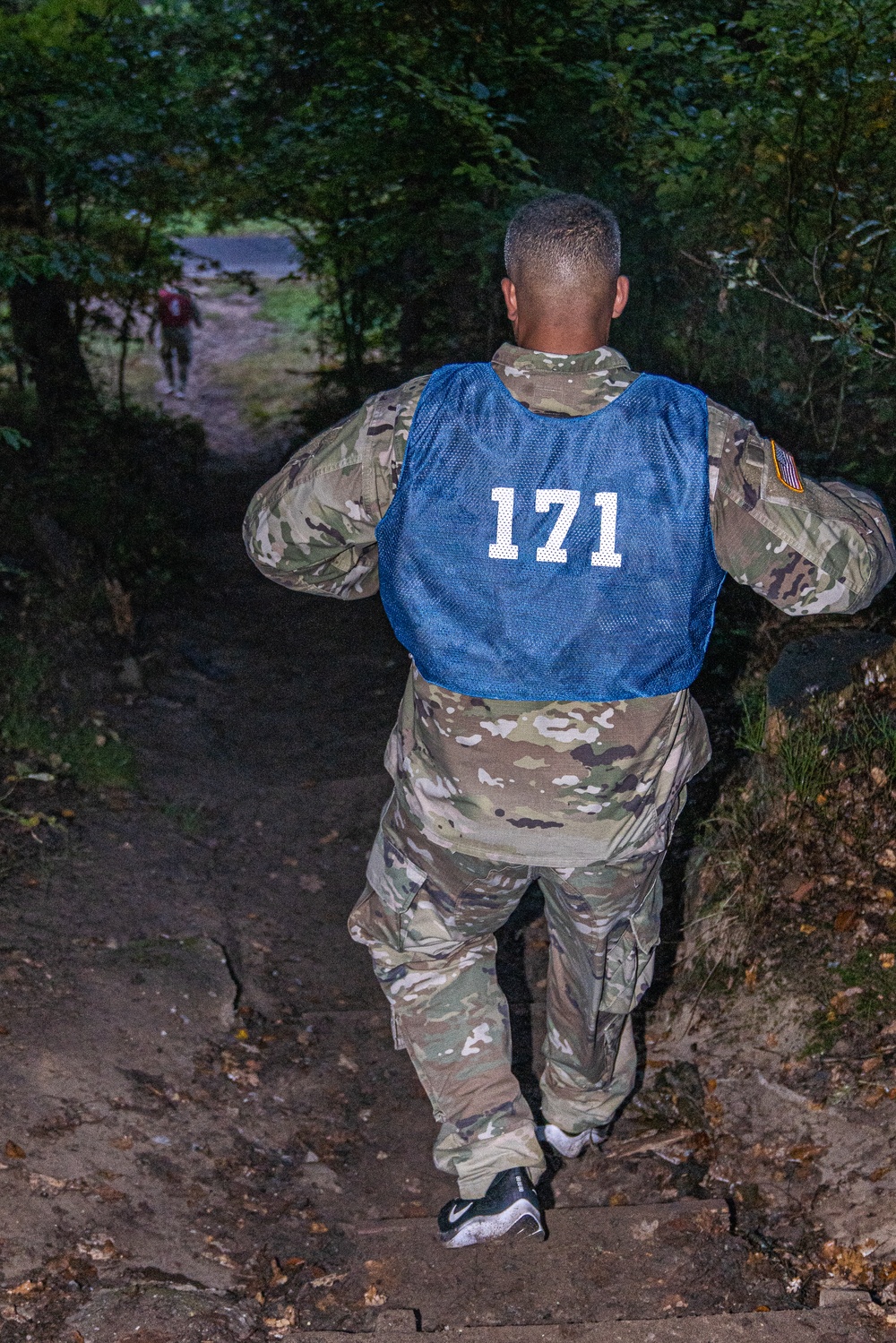 Soldier of the year competitor runs through tunnel of trees