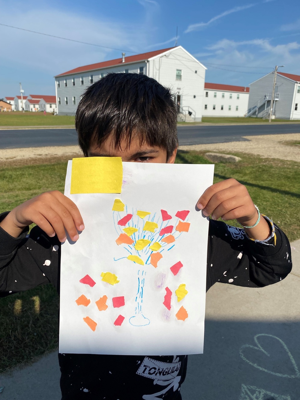 Afghan evacuee child at Fort McCoy shows fall artwork
