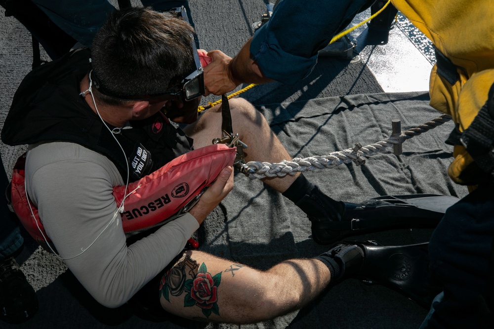 USS Sioux City Sailors Secures Himself in a Rescue Strop During a Shipboard SAR Exercise