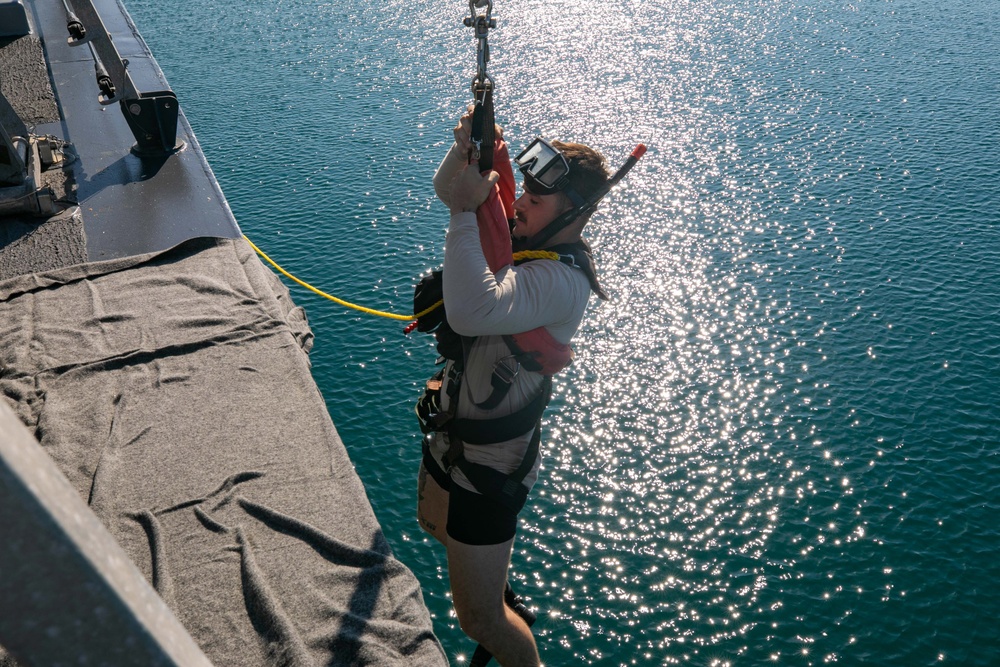 USS Sioux City Sailor Descends Into the Water Using a J-Bar Davit During a SAR Exercise