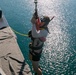 USS Sioux City Sailor Descends Into the Water Using a J-Bar Davit During a SAR Exercise