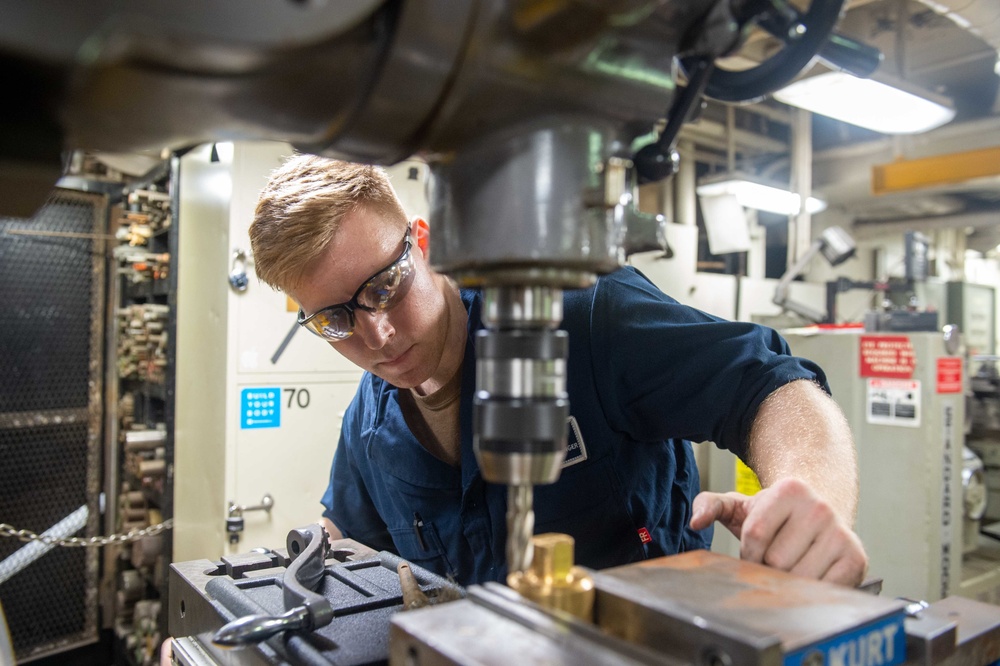 USS Carl Vinson (CVN 70) Sailor Operates Machinery