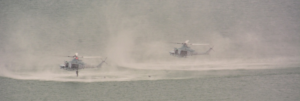 Two UH-1Y Venoms attached to Marine Light Attack Helicopter Squadron (MLA) 269 drop marines off in the ocean