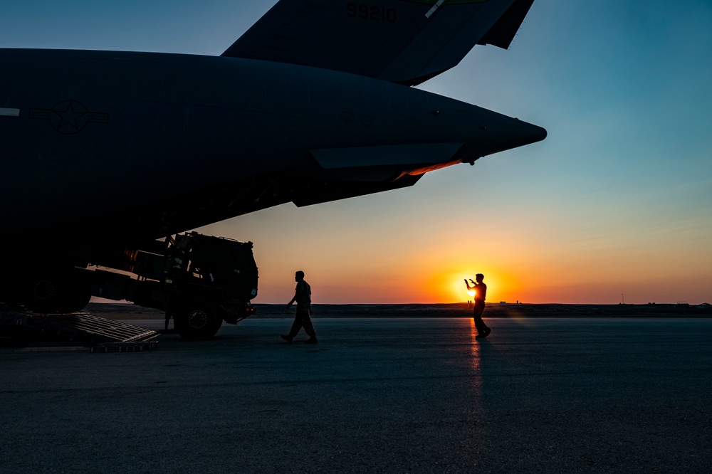 U.S. Air Force Loadmaster Guides U.S. Army M142 High Mobility Artillery Rocket System Into Aircraft