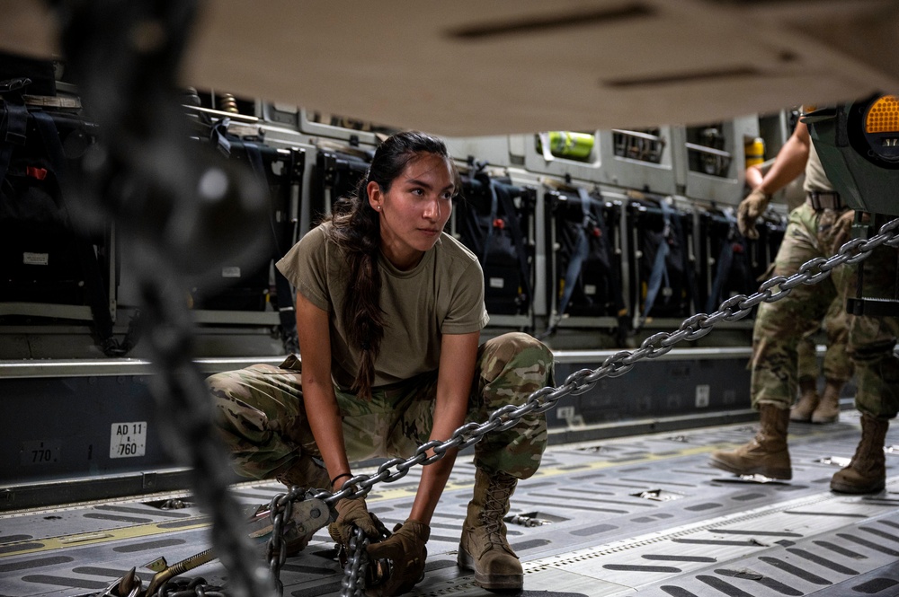 U.S. Air Force Airman Secures Vehicle To Aircraft