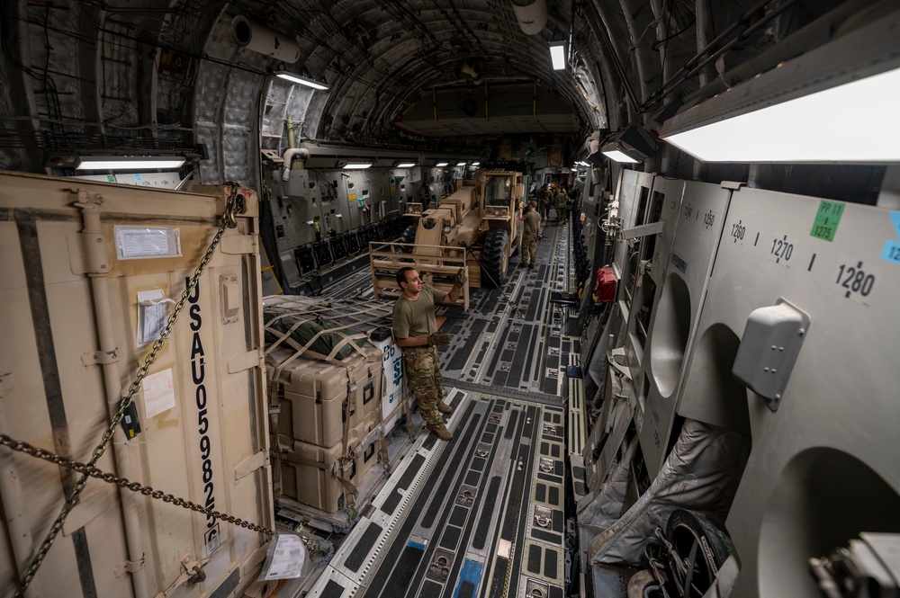 U.S. Air Force Loadmaster Ensures Cargo Is Secured Properly