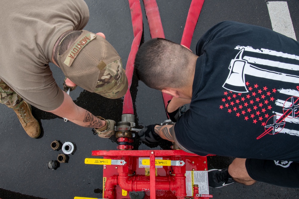 Firefighters check a kilometer of firehoses