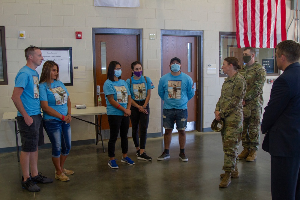 Personnel stationed at Camp Atterbury welcome the family of fallen service member