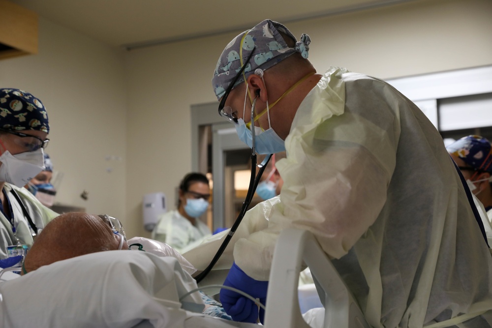 U.S. Army Medical Response Team Members Provide Care to a COVID-Positive Patient 