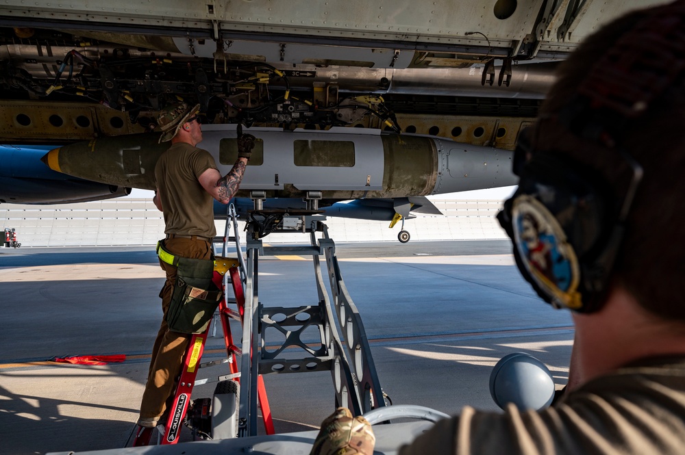 Air Force Weapons Load Crew Members Load Munitions