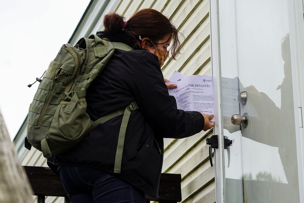 FEMA Disaster Survivor Assistance Specialist Places Spanish Language Literature in Door of Survivor