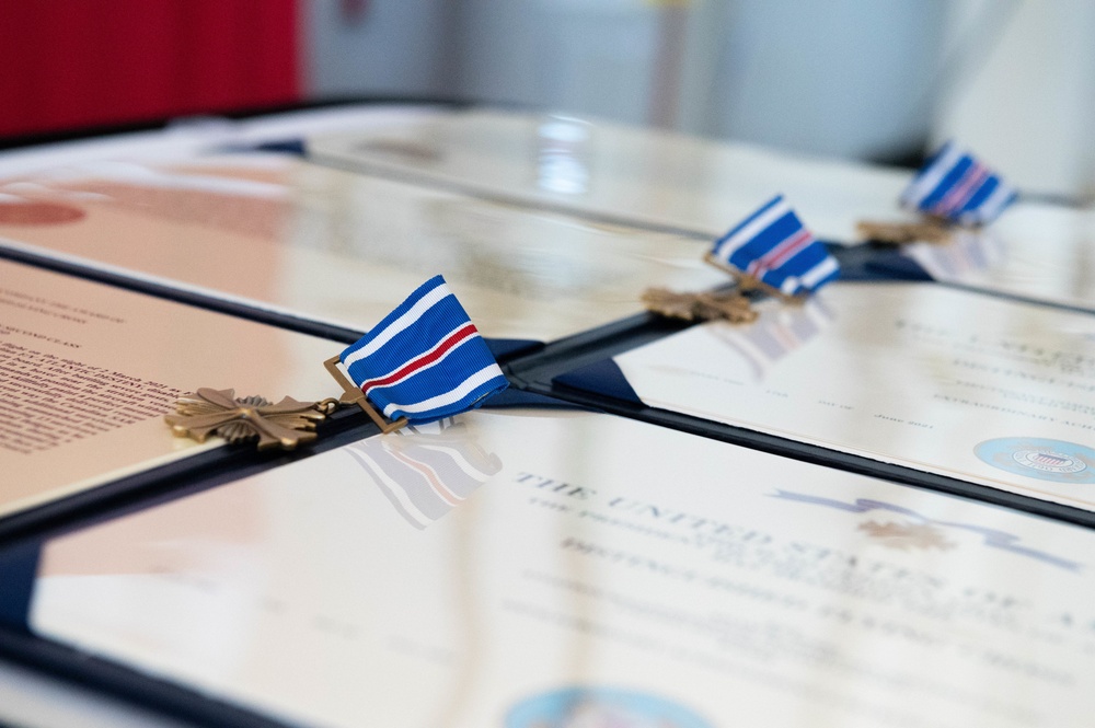 Adm. Karl Schultz, the commandant of the Coast Guard, presents awards to members of Air Station Cape Cod