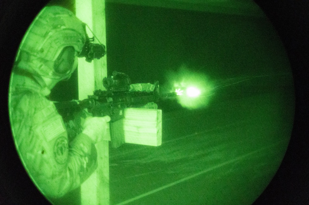 A 934th Security Forces Squadron Airman fires his M-4 during a simulated night fire training