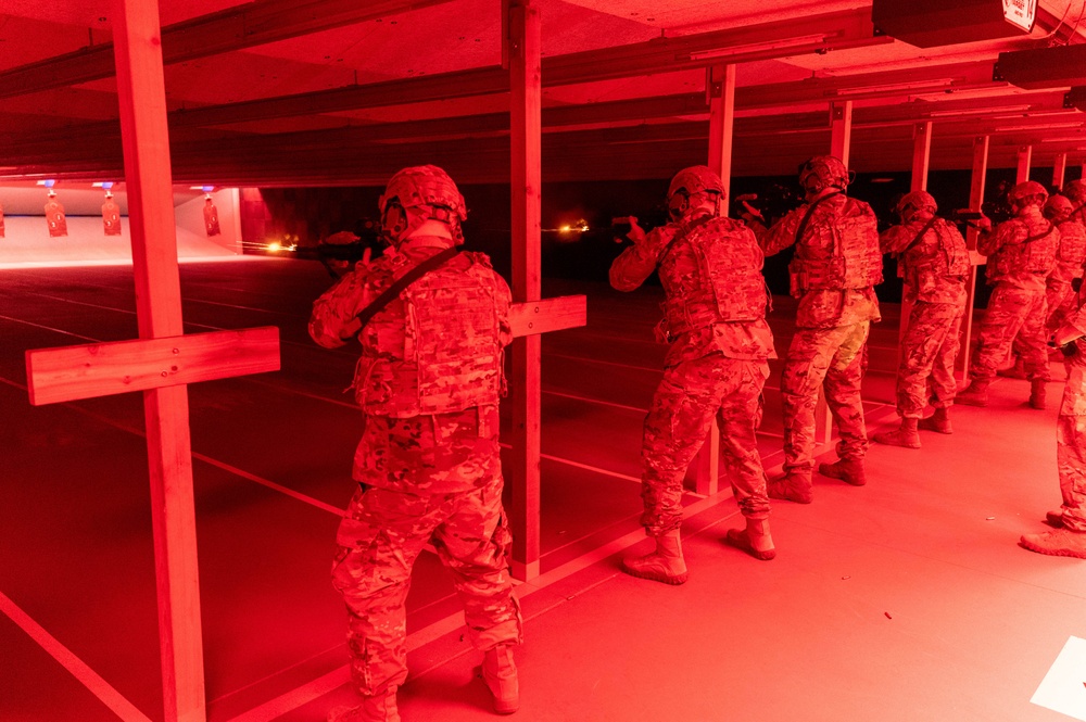 934th Security Forces Squadron Airmen fire their M-4 rifles during a simulated night fire training