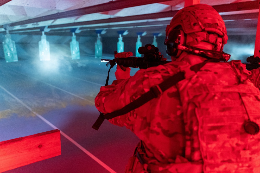 A 934th Security Forces Squadron Airman fires his M-4 during a simulated night fire training