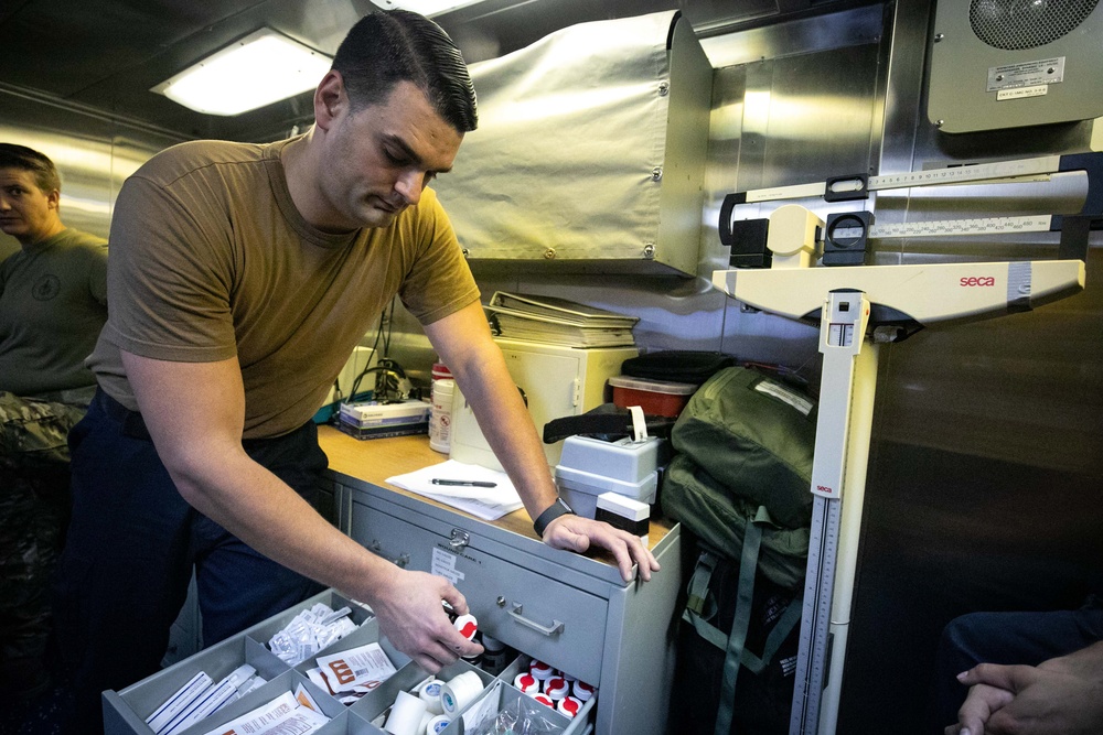 USS Sioux City Sailor Checks Medical Supplies While Holding EMRT Training