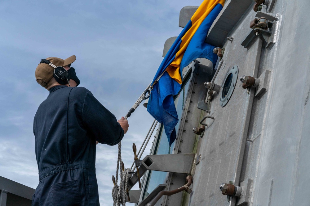 USS Jackson (LCS 6) Sailor Hoists Kilo Flag