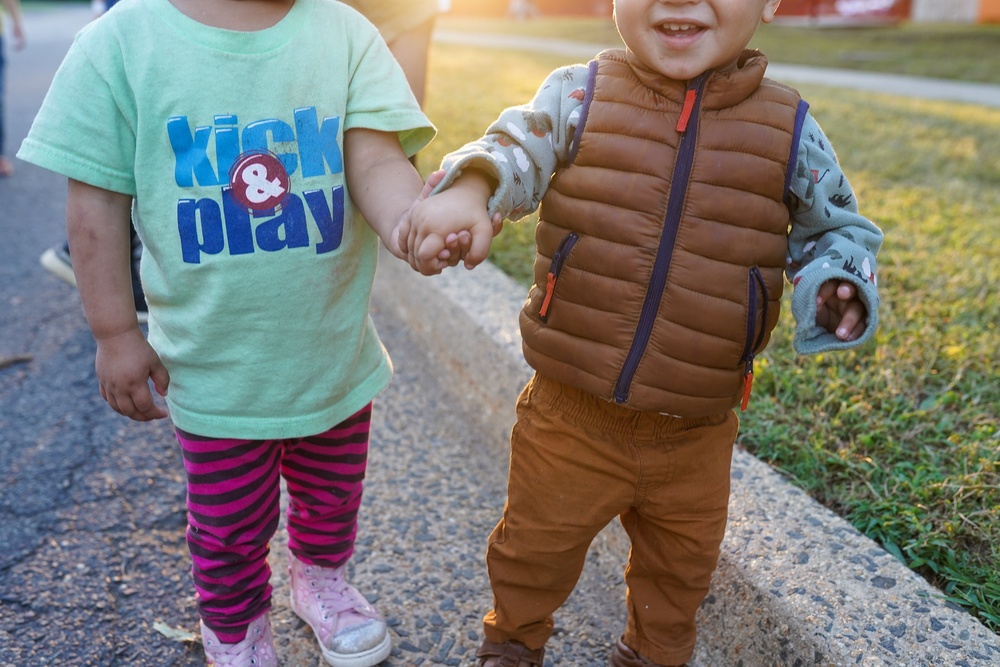Afghan children hold hands in Liberty Village