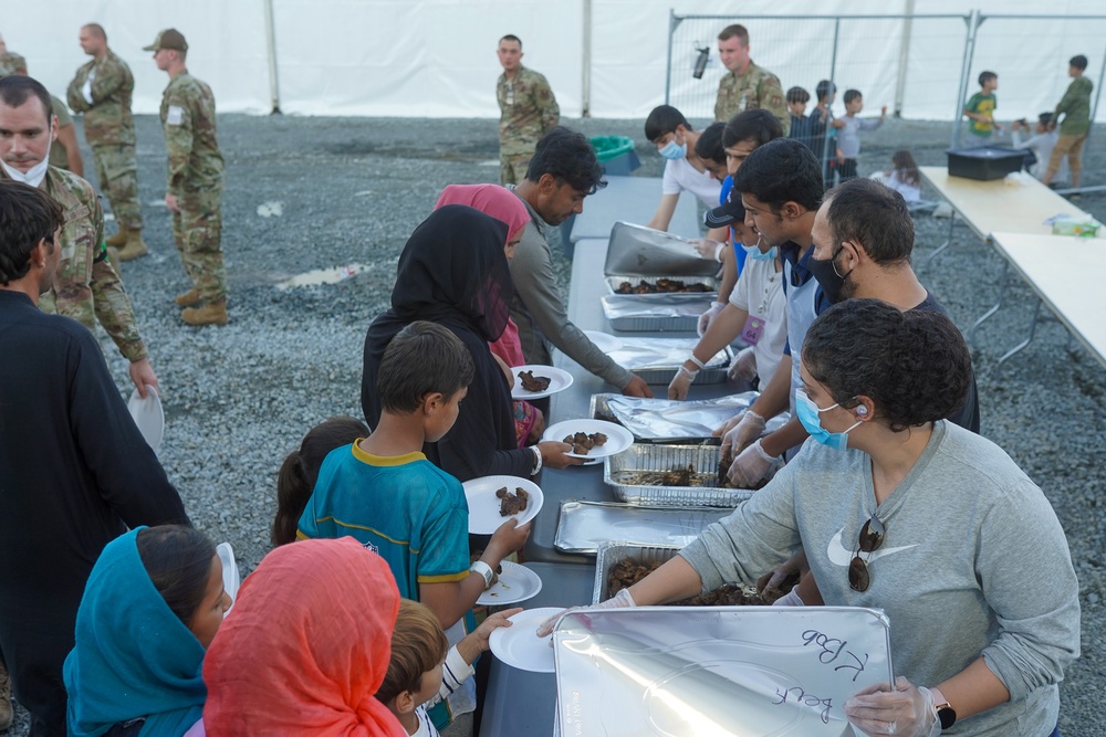 Afghan guests are served kebabs in Liberty Village