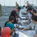 Afghan guests are served kebabs in Liberty Village
