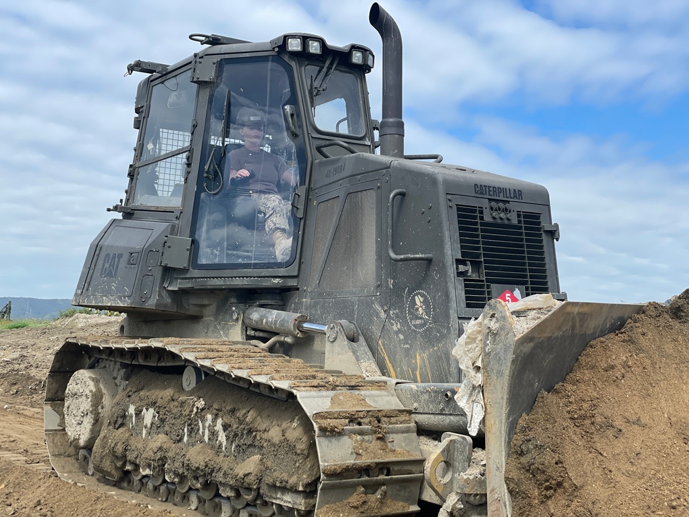 U.S. Navy Seabees with NMCB-5 work on the landfill capping project