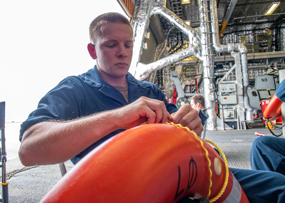 USS Charleston Sailor Conducts Maintenance on Life Ring