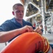 USS Charleston Sailor Conducts Maintenance on Life Ring