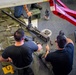 USS Charleston Sailors Conduct Maintenance on a GAU Machine Gun