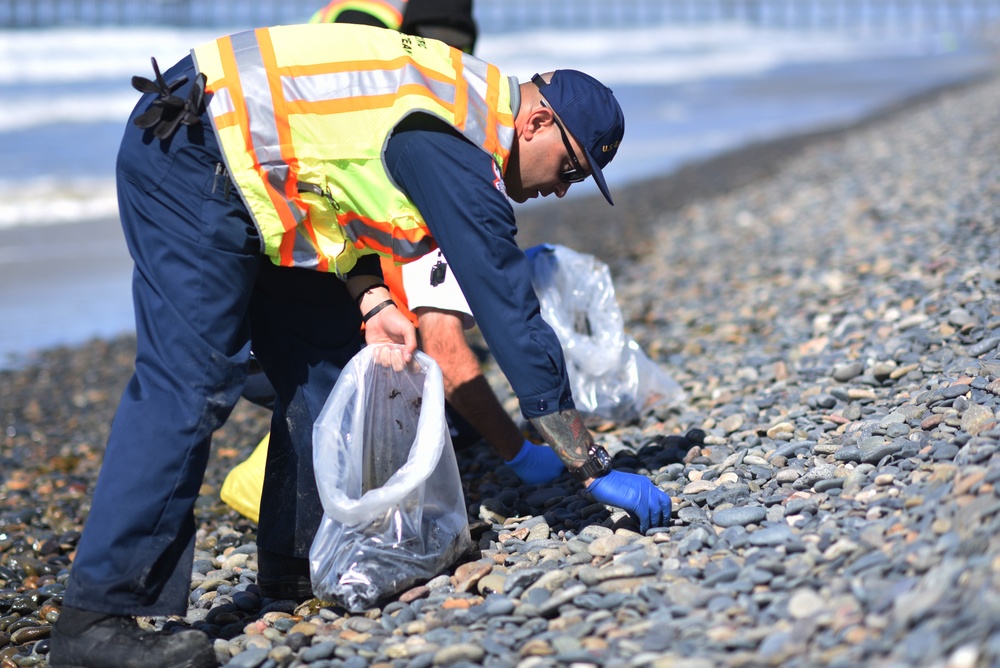 Tar balls being removed from shores in Oceanside Harbor Beach in San Diego County
