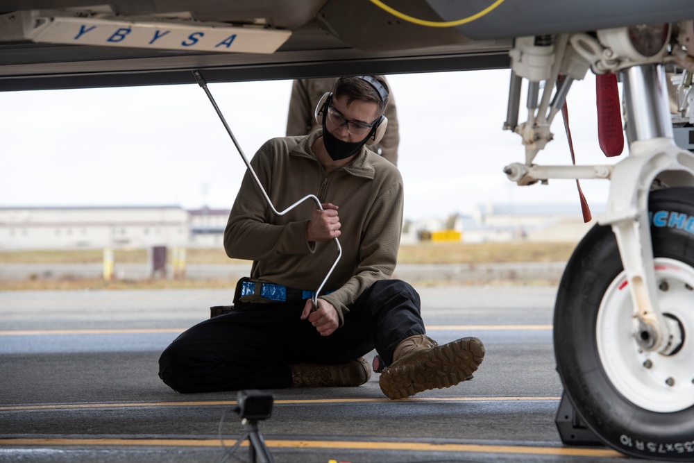 525th Aircraft Maintenance Unit Airmen arm F-22 Raptors during the Weapons Load Crew of the Quarter competition